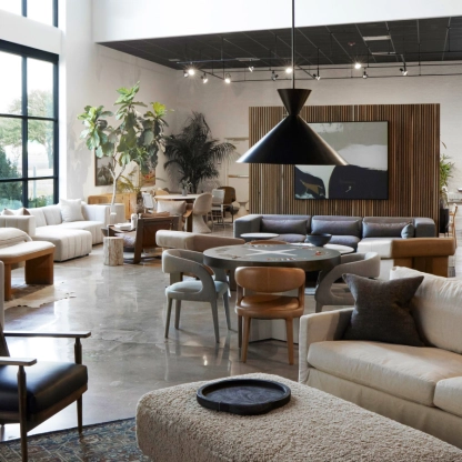 Modern interior showcasing various stylish sofas, chairs, and decor items in a well-lit room.