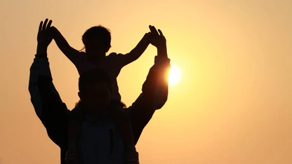 silhouette of father and daughter