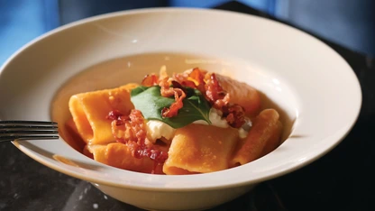 The paccheri ai tre pomodori features a delicate, flavorful tomato sauce topped with crispy bacon and creamy burrata PHOTO BY ARMANI THAO