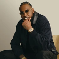 Dior jacket; Burberry cotton sateen cargo trousers; Rolex Day-Date; David Yurman Chevron band ring in 18K yellow gold, Streamline band ring in 18K yellow gold with diamonds and Chevron woven bracelets in 18K yellow gold and black nylon; Anthony’s own glasses.