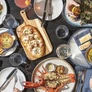 A spread of food featuring items from the main dinner menu and The Current, a curated, rotating menu celebrating one purveyor PHOTO BY REAGAN BYRNE