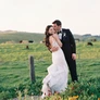 The groom kisses his bride. Photographed by AIMI GALLEGO