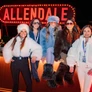 Five women wearing winter outfits posing at a bar with a bright ALLENDALE sign in the background.