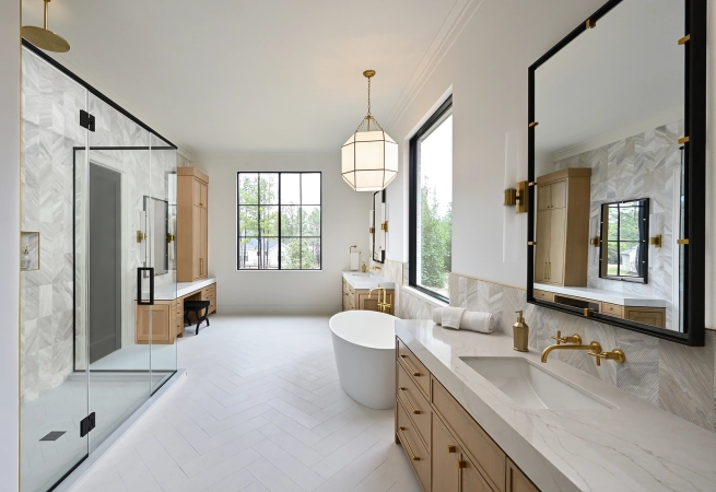 Modern bathroom featuring a freestanding tub, large windows, and elegant fixtures.
