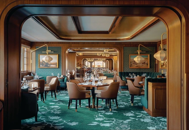 In the dining room, the palette is intentionally warm, allowing materials to convey richness without relying on contrast