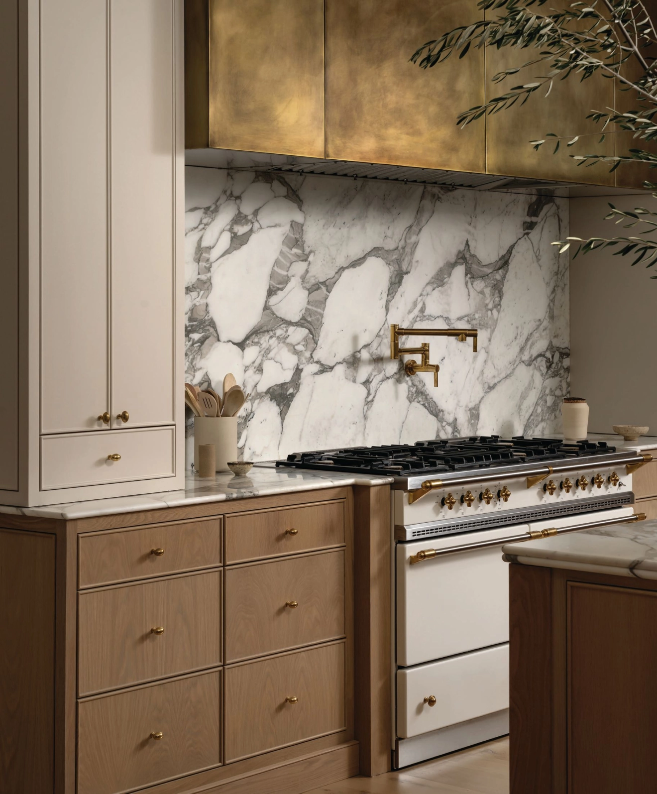 “We believe in letting the materials speak,” Barton says, citing this kitchen with a custom brass hood and honed Arabescato Vagli backsplash. “Every space includes quiet details that reveal themselves over time—nothing flashy, but everything intentional.” Interiors photography by CHASE DANIELS