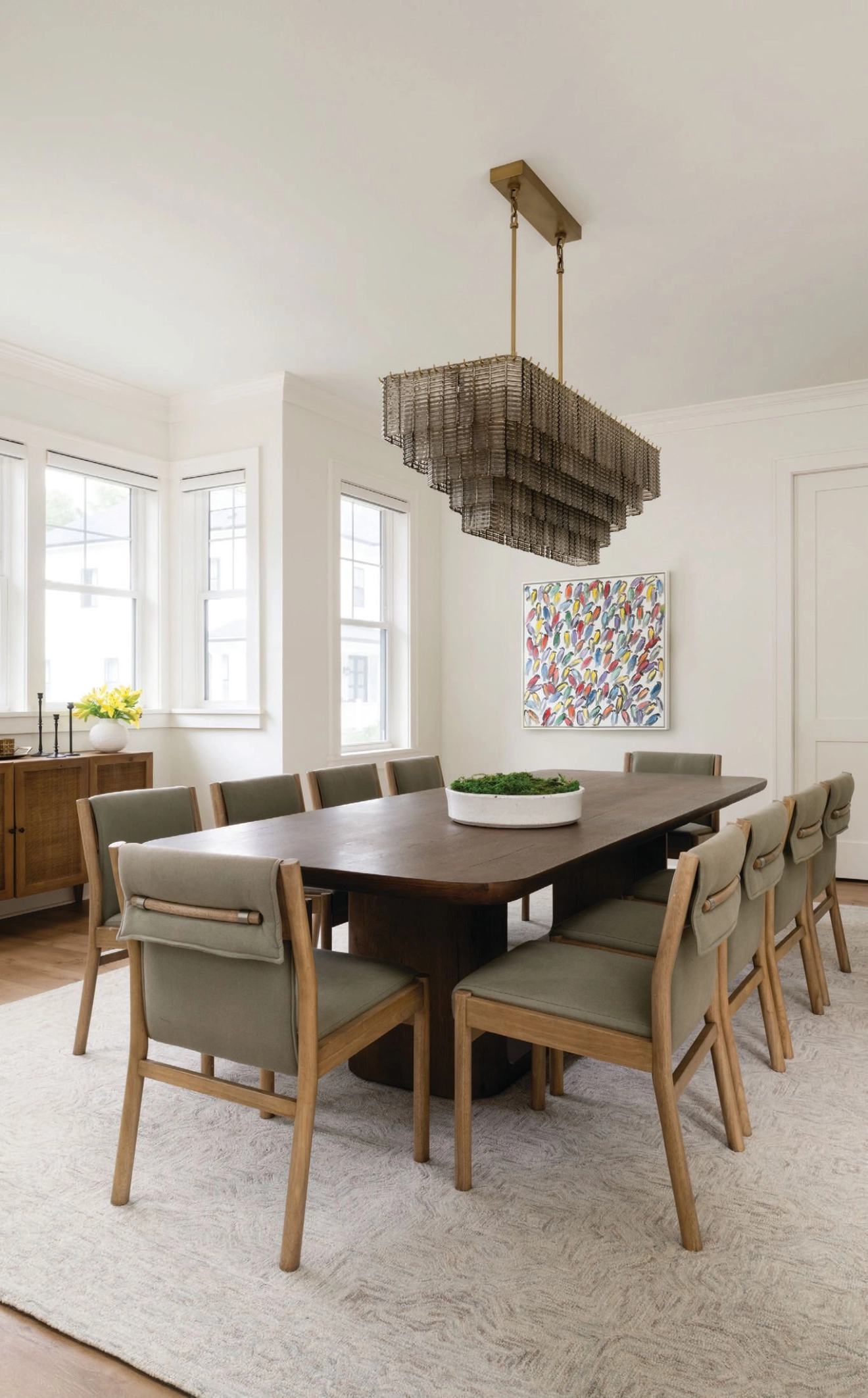 The dining room features an Oslo Open table, chairs and a chandelier from RH. photographed by ROBERT RADIFERA styled by CHARLOTTE SAFAVI
