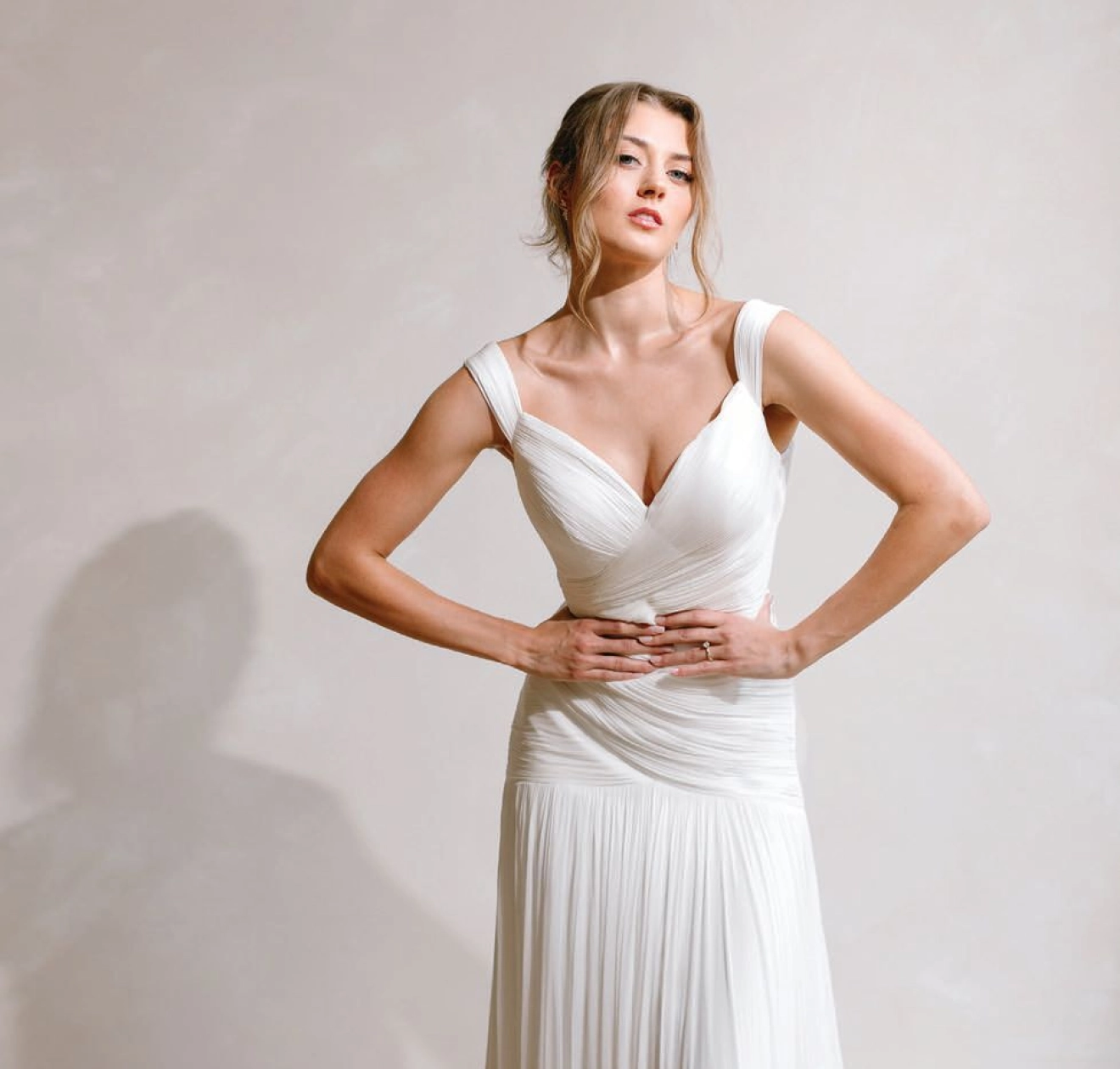 Yanni Design Studio enriched the setting with elegant candles, drapery and artfully arranged centerpieces with roses, orchids and greenery.PHOTO BY NELA PHOTOGRAPHY