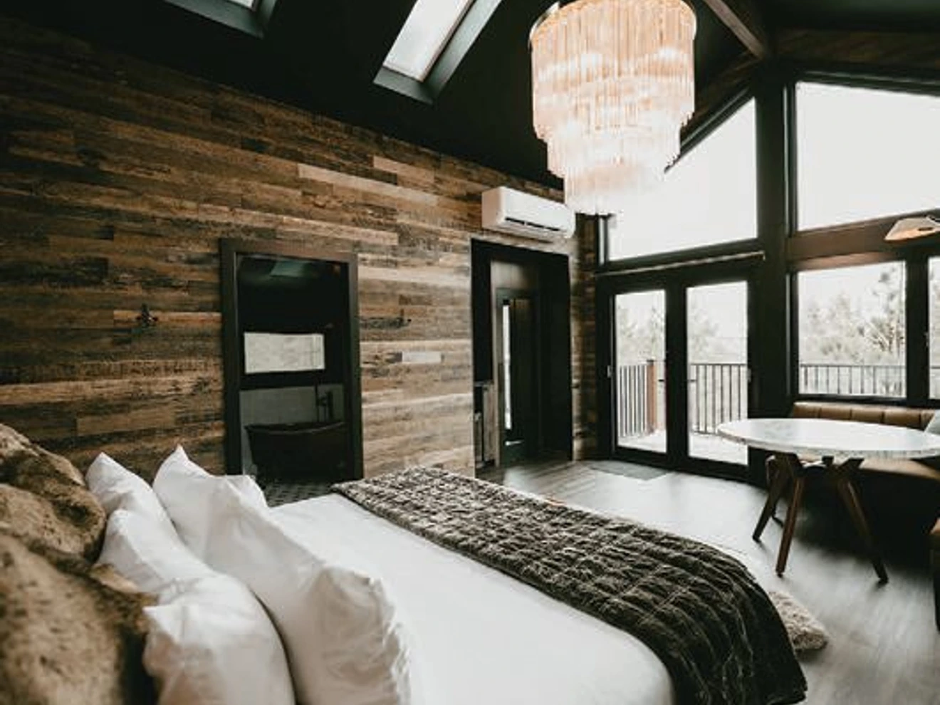 A crystal chandelier lights the Miner's Treehouse with unexpected elegance. PHOTO BY KATE IVY PHOTOGRAPHY