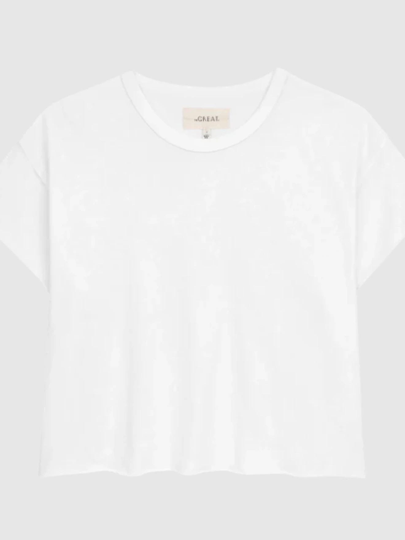 White cropped short-sleeve T-shirt with a round neckline on a plain gray background.