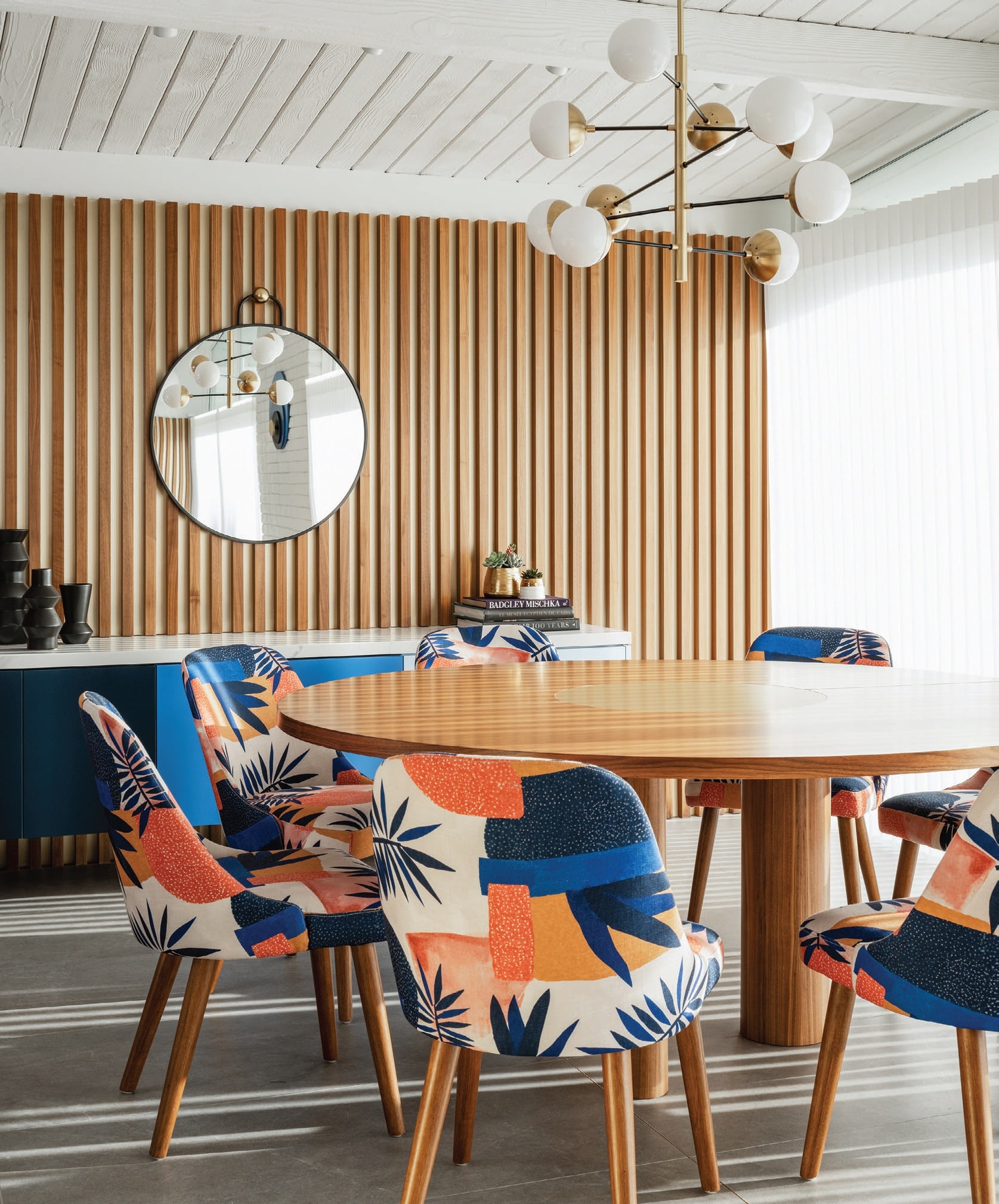 For the dining room, Boudreau designed a large round walnut table with legs of varying diameters. PHOTOGRAPHED BY LANCE GERBER