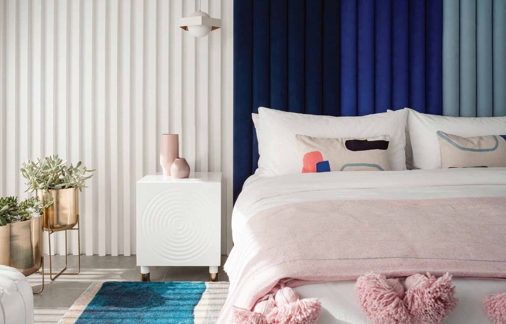 Boudreau designed the primary bedroom’s floor-to-ceiling channel-tufted headboard. PHOTOGRAPHED BY LANCE GERBER