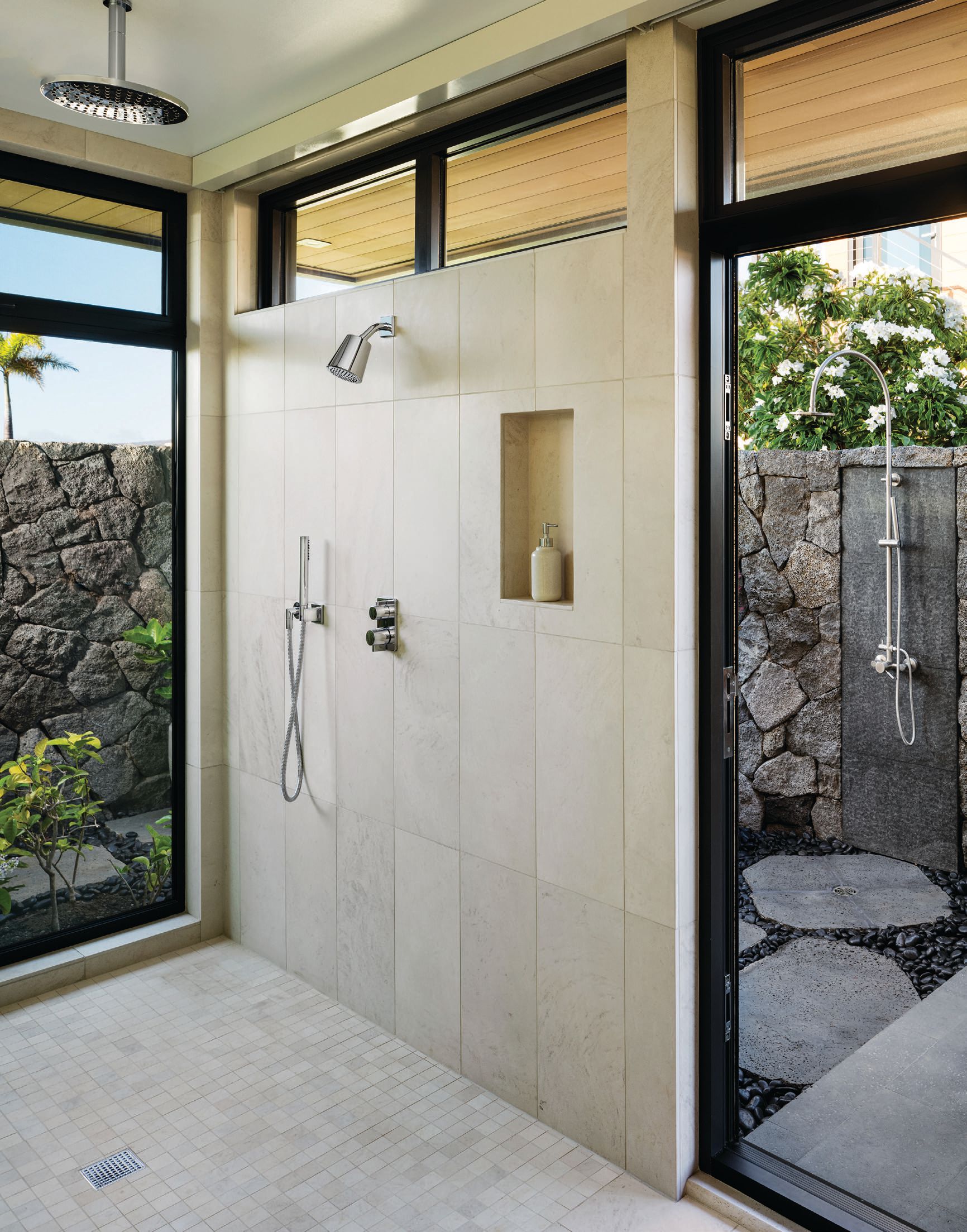 The primary bathroom includes both indoor and private outdoor showers. Photographed by Ethan Tweedie
