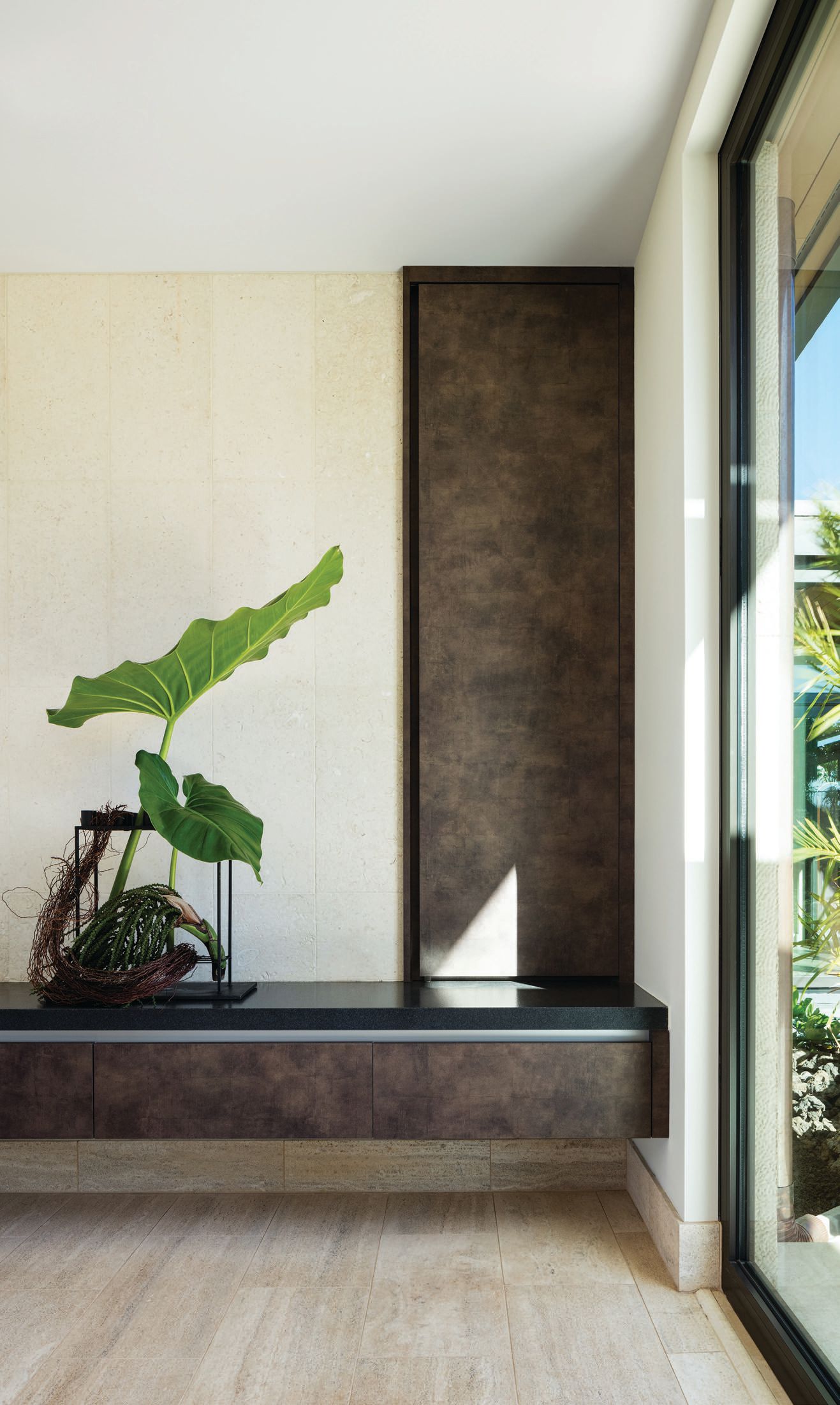 The entry foyer sitting bench includes a recessed shoe cabinet. Photographed by Ethan Tweedie