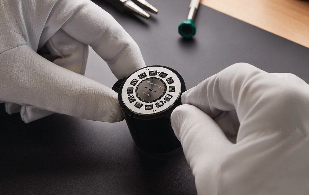 A watchmaker carefully inspects the LV 77 caliber, the movement that powers the Louis Vuitton Escale Spin Time. PHOTO COURTESY OF LOUIS VUITTON
