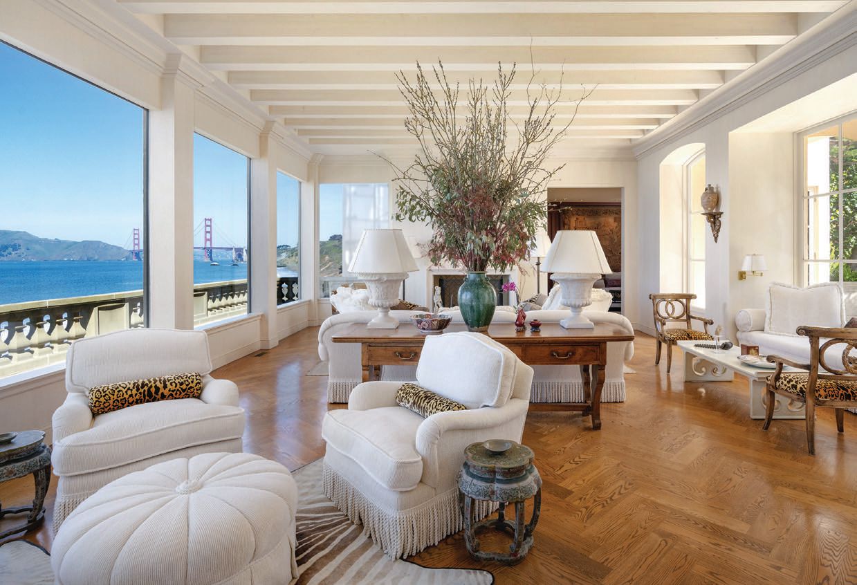 The great room boasts breathtaking views, exposed beams and herringbone wood flooring