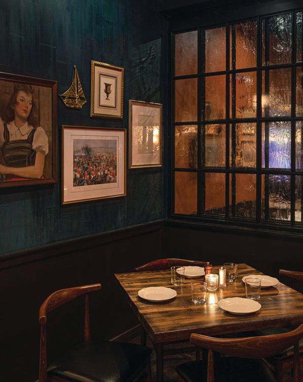 A cozy corner table beckons in the low-lit dining room. PHOTO BY NEIL BURGER