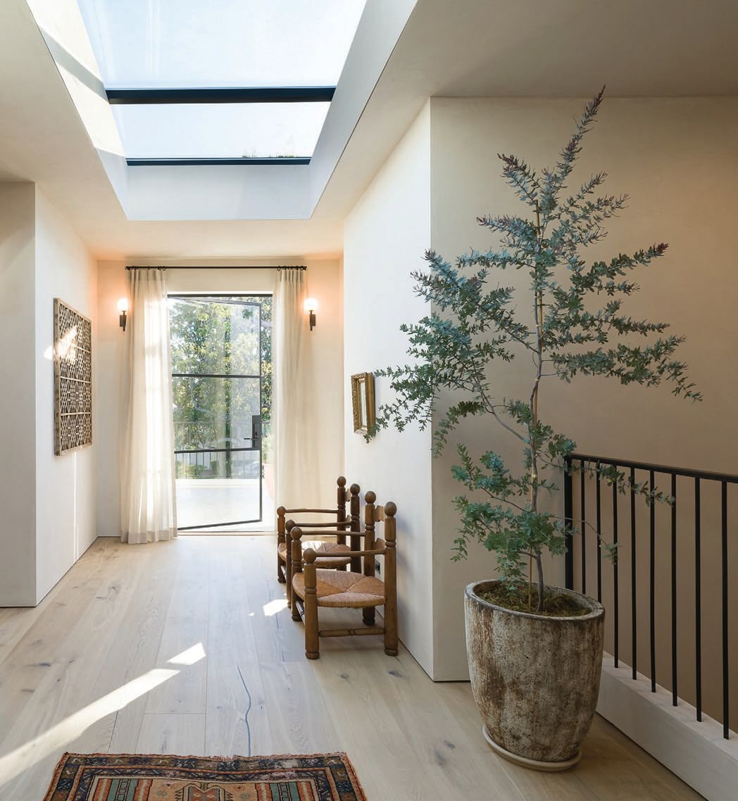 One of Brady’s favorite moments is on the landing, where a pair of Charles Dudouyt oak and paper-cord chairs from Amsterdam Modern reside. “There is so much character here yet we still managed to stay minimal and clean,” she says PHOTOGRAPHED BY TODD GOODMAN