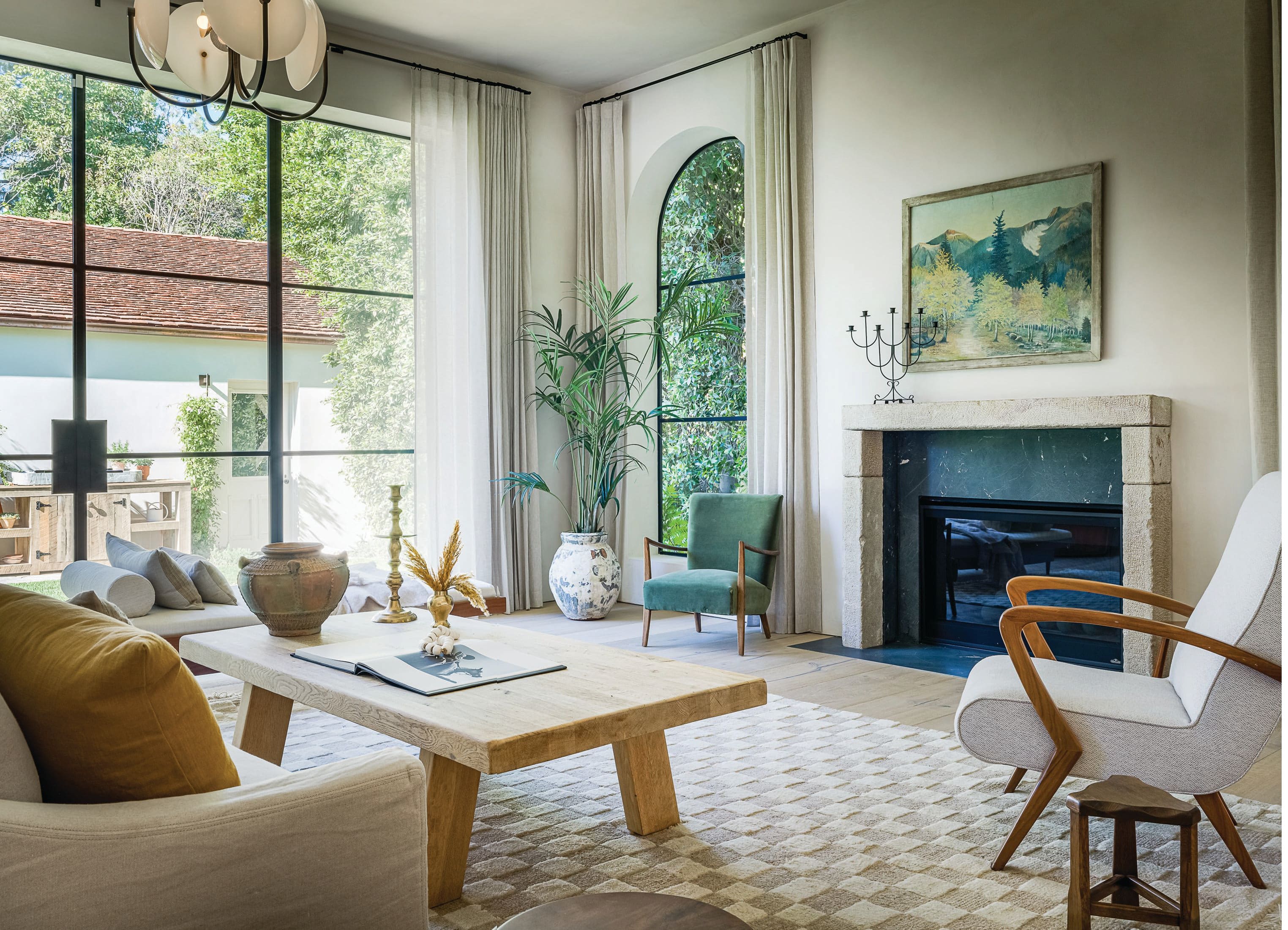 The living room has a modern European feel, and offers guests a variety of unique spaces to sit or lounge. “The vintage coffee table from Amsterdam Modern is the focal point of the room,” says Brady. “It draws you into the center and holds your attention.” PHOTOGRAPHED BY TODD GOODMAN