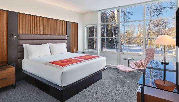 Originally designed by Harry Bertoia in 1952, the Bird chair (to the right of the bed) was carefully restored and reupholstered in a heritage textile in Bayer’s signature primary colors PHOTO COURTESY OF SALAMANDER HOTELS & RESORTS