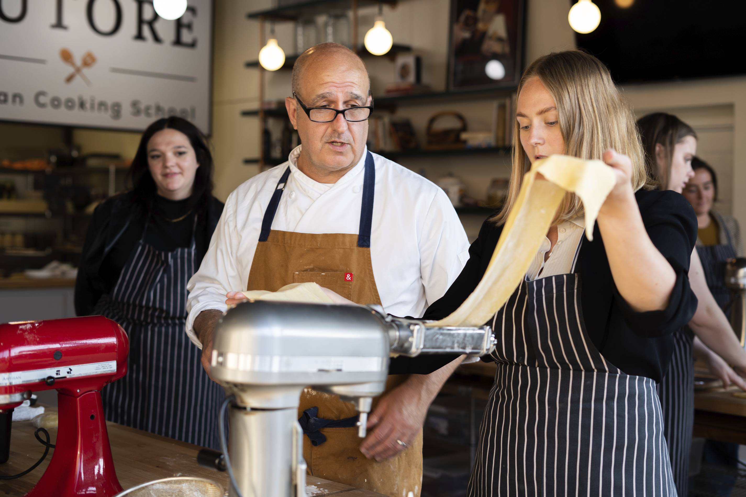 chef Dean Zanella with a student at tutore italian cooking school in chicago