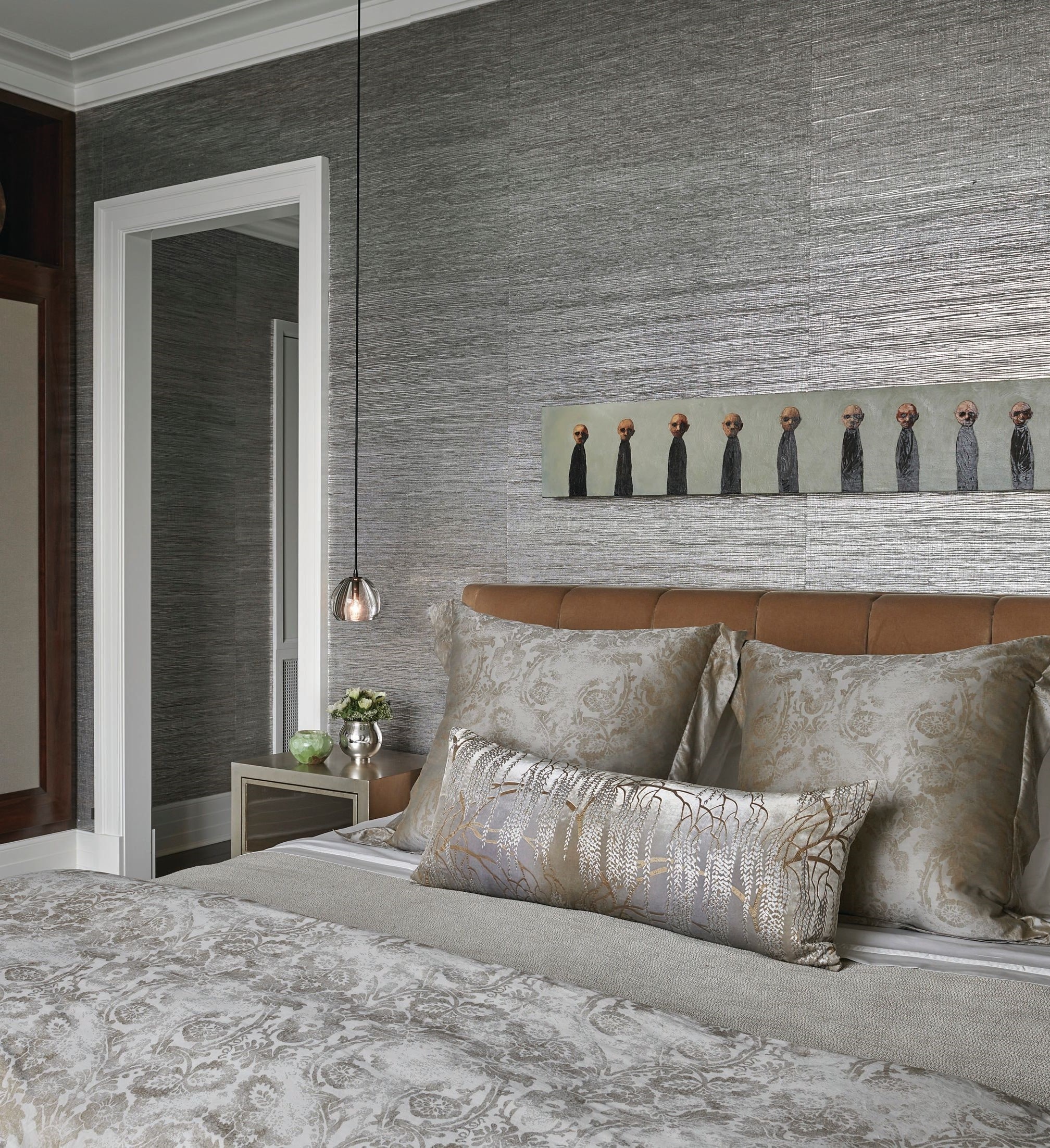 Wild Flax wallpaper in Gunmetal by Carlisle & Co., Alison Berger Glassworks pendants, and art by Lora Fosberg from the client’s own collection draw the eye in the primary bedroom. PHOTOGRAPHED BY TONY SOLURI