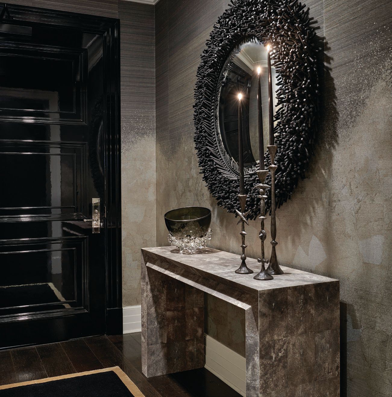 A black lacquer door, Phillip Jeffries Metallic Ombre wallpaper in Pewter on Shetland horsehair, and a Christian Astuguevieille black rope mirror add up 				to a seriously dramatic foyer.  PHOTOGRAPHED BY TONY SOLURI