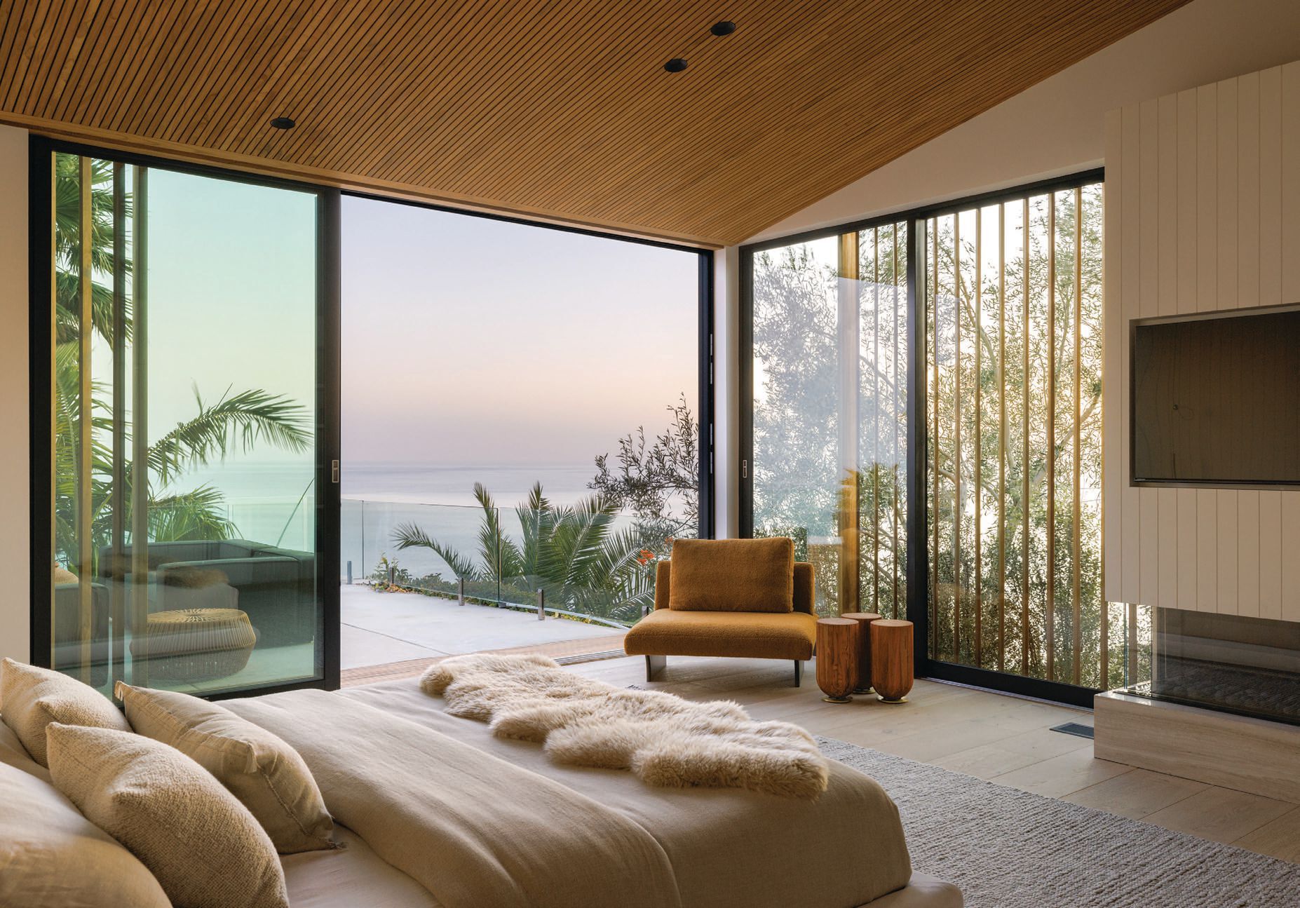 Portola’s Sea Salt paint shade coats the primary suite, which features furniture from ATRA, Current Collection’s Strike lighting and a stunning ocean view. PHOTOGRAPHED BY VIRTUALLY HERE STUDIOS