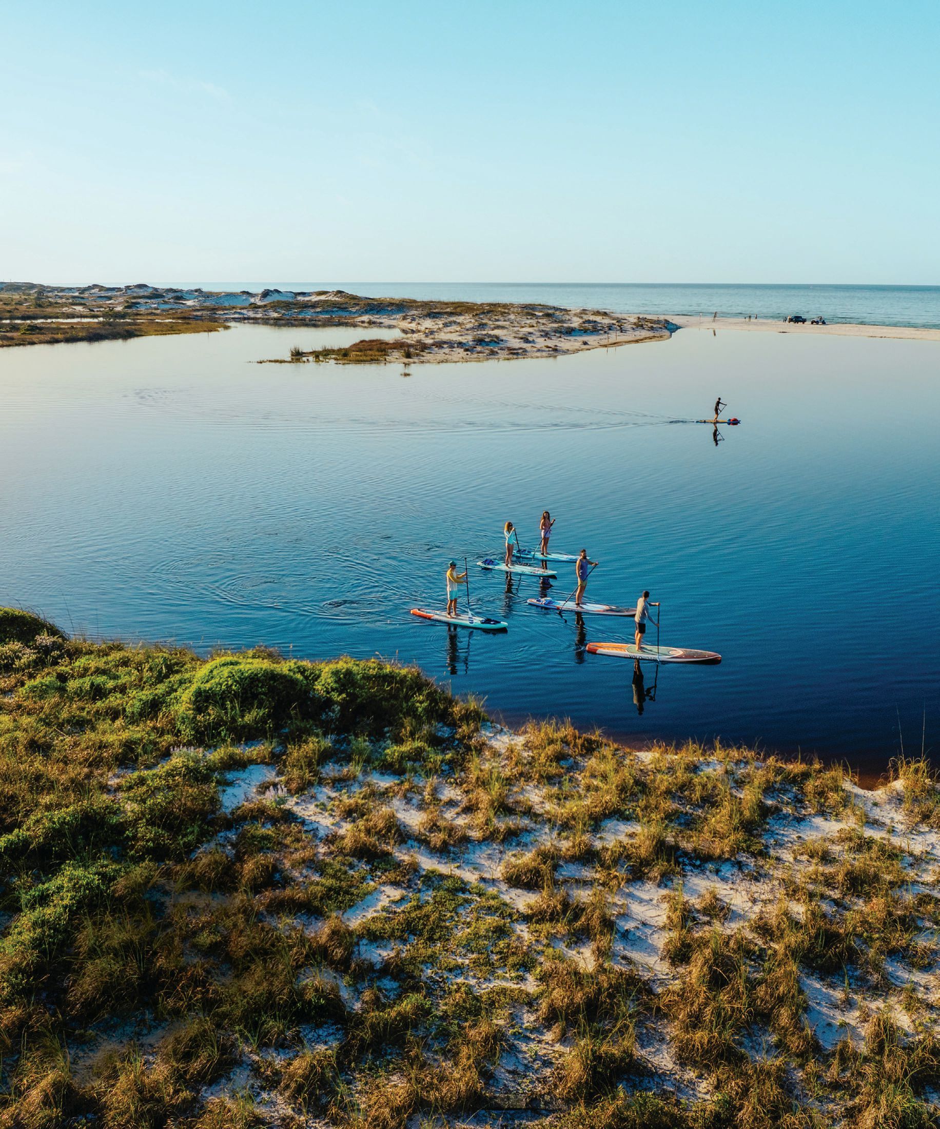Stand-up paddleboarding on a coastal dune lake at Santa Rosa Beach in South Walton, Fla. PHOTO COURTESY OF WALTON COUNTY TOURISM