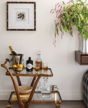 a bar cart from Chairish adds to the living roomâs appeal. photographed by JENN VERRIER