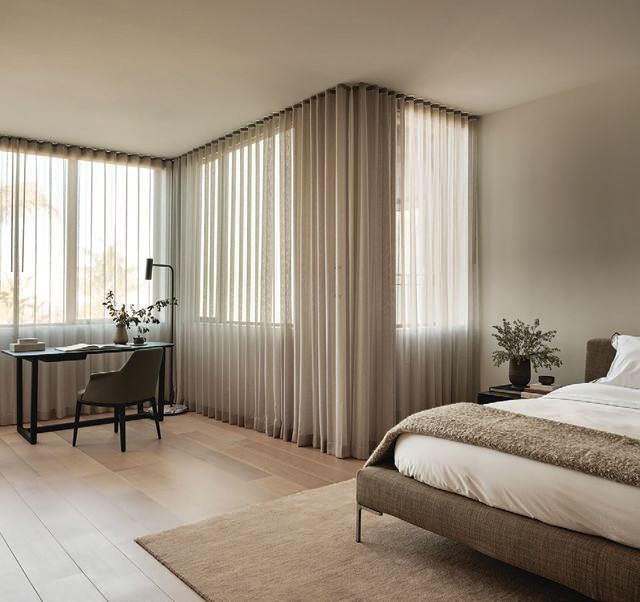 A bed from B&B Italia and a study nook furnished by Poliform grace the primary suite. photographed by R. BRAD KNIPSTEIN PHOTOGRAPHY