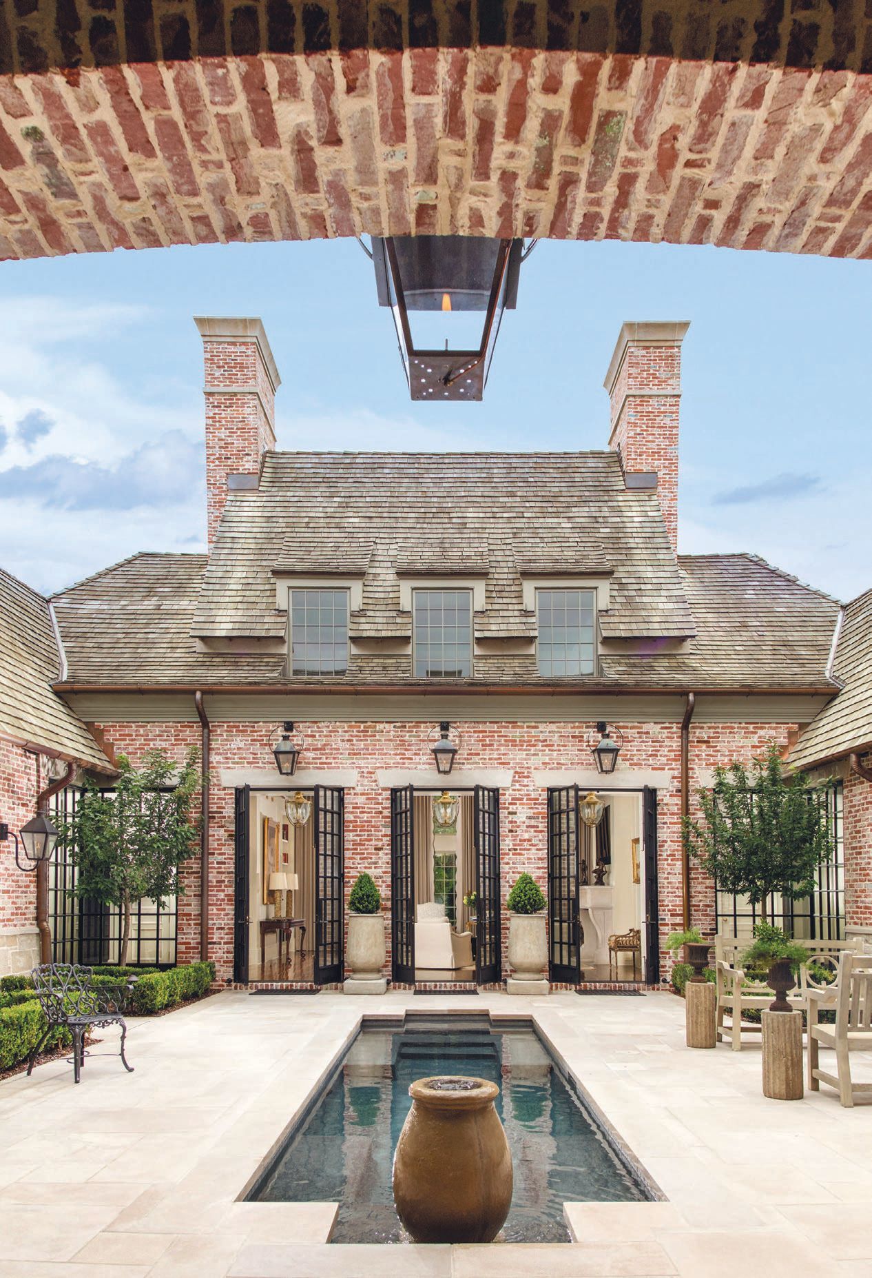 The courtyard features a cocktail pool and intimate seating areas, perfect for entertaining.