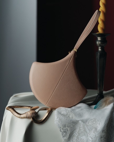 Bvlgari Ginkgo clutch in Star Rose Pink calf leather and suede with crystal rose nappa leather lining and leather wristlet; Serpenti yellow gold necklace, bulgari.com. Photographed by JONG HYUP