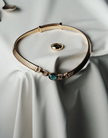 Bvlgari Cabochon 18K yellow gold ring; Tubogas 18K yellow gold necklace set with a central blue topaz and pavÃ© diamonds, bulgari.com. Photographed by JONG HYUP