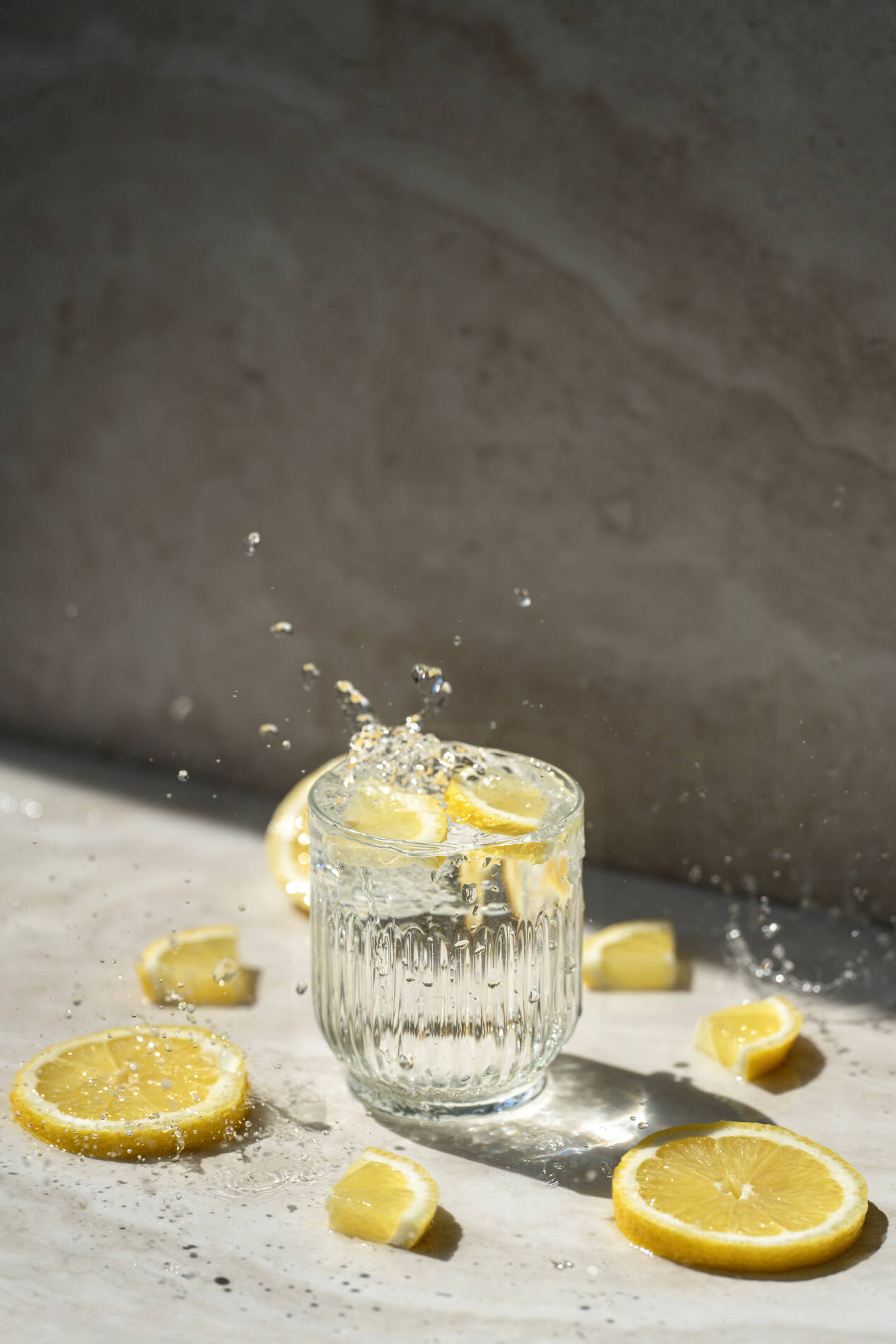 Glass of water with lemon and splash