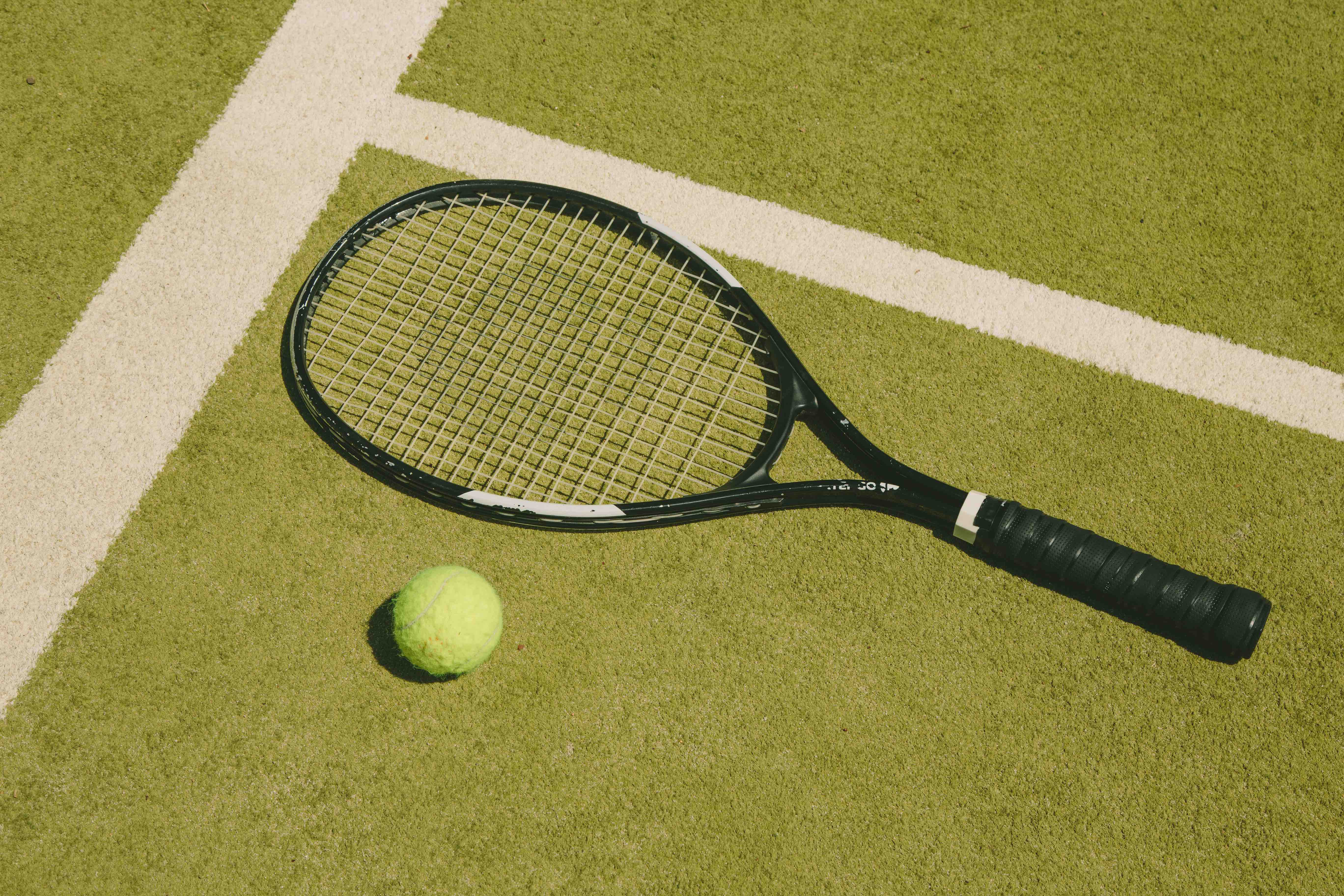 Tennis racket on green fields