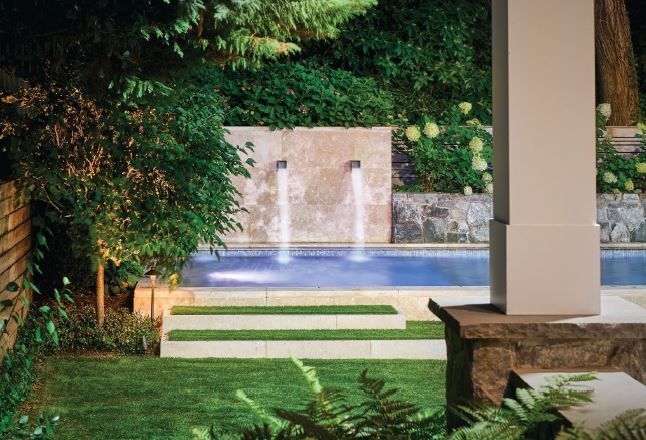 The pool is intentionally elevated above grade, which allows the coping to function as a seat wall from the lawn side. PHOTO BY CURT PHOTOGRAPHY