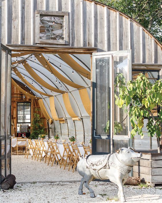 The farmâs signature harvest dinner inside the greenhouse, warmly lit and communal. PHOTO COURTESY OF CAPE RESORTS