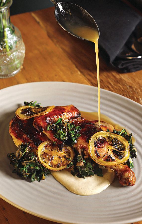 Honeysuckleâs Epis roasted chicken with grilled collards, candied lemon and charred leek aioli. BY HAAMZA EDWARDS