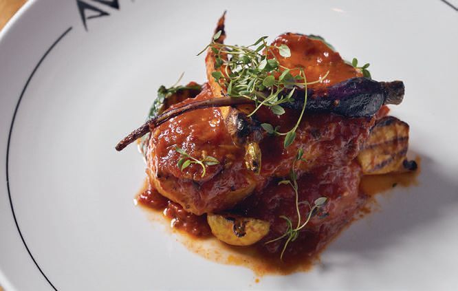 The oven-baked Chilean sea bass "Plaki" with Vidalia onions, potatoes and herbs in a light tomato fish broth. PHOTO BY MICHAEL BLANCHARD