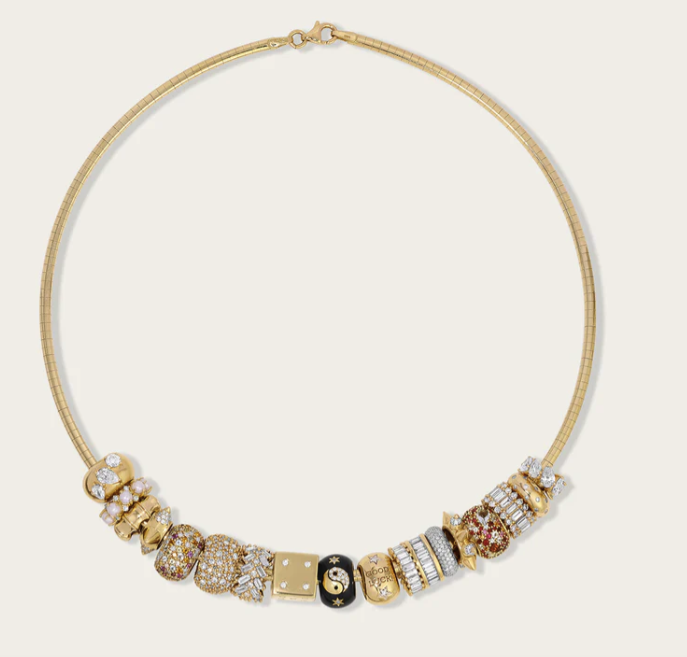 Gold choker necklace with various decorative beads featuring gemstones and intricate designs.