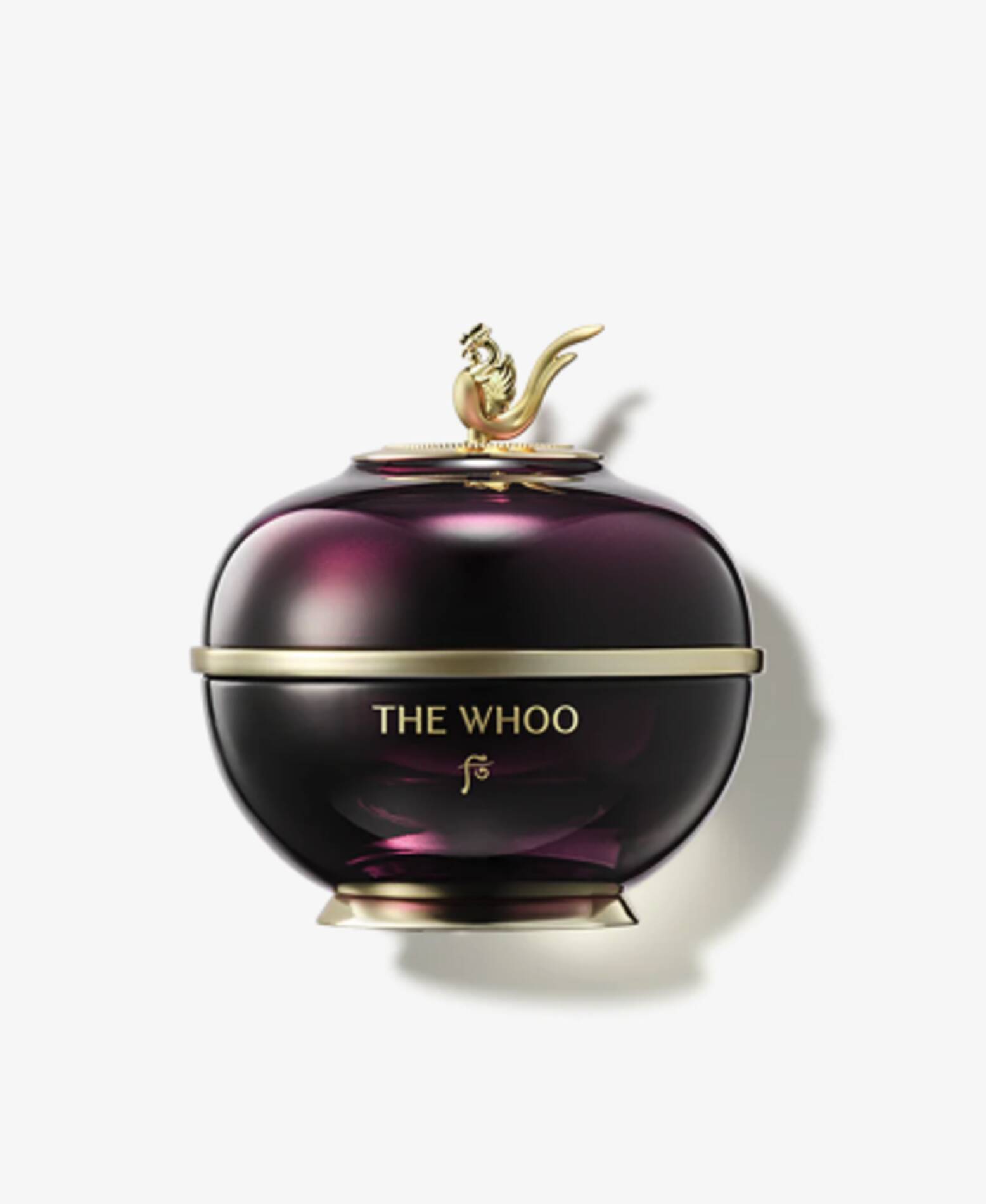 Dark purple and gold ornate cosmetic jar labeled THE WHOO on white background.