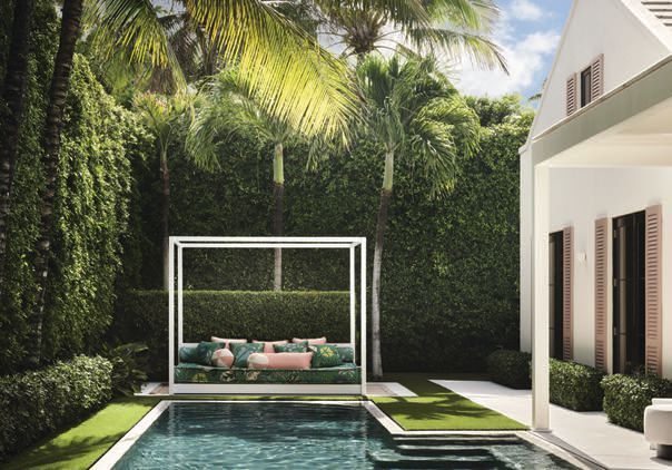The custom Alice in Wonderland pool daybed by Martyn Lawrence Bullard Atelier, painted in Benjamin Mooreâs Decoratorâs White CC-20, is layered with pillows in Perennialsâ Loop De Loop in Blanca, Summit Furnitureâs Di Medici in Blush and Samuel & Sonsâ Terrace chenille loop fringe. In the upstairs sitting room, Martyn Lawrence Bullard Atelier seating pairs with Palmier wallcovering in Blanche from his collection. The Shade Store drapery and Russell Youngâs Marilyn Monroe diamond-dust artwork complete the layered space.