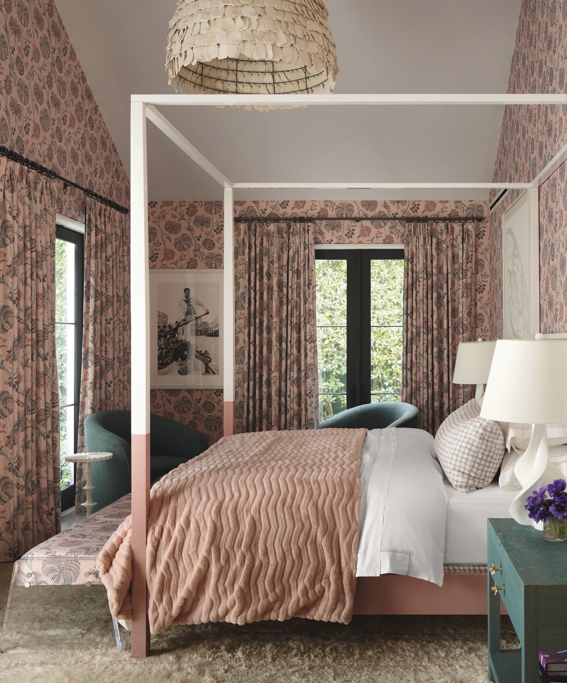 The primary bedroom layers a custom lacquer bed, bedside tables and club chairs by Martyn Lawrence Bullard Atelier with Boheme and Turquerie fabrics from his collection. Phillip Jeffries grasscloth, Pindler upholstery, Scandia Home bedding, an Opuz blanket, a Woven rug, Visual Comfort & Co. lamps, a Handmade Story pendant and Katrien van der Schueren artwork add luxe layers to the retreat. PHOTO BY HOPE ROLLINS
