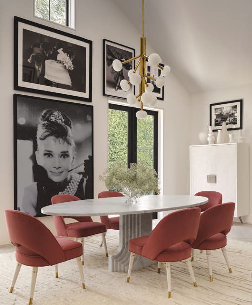 A vintage Carlo Scarpa dining table anchors the dining room beneath an Atelier de Troupe Etoile chandelier, surrounded by Martyn Lawrence Bullard Atelier chairs upholstered in Toray Ultrasuedeâs Marsala. A lacquer-and-bronze cabinet from Hive Palm Beach, Russell Youngâs Audrey Hepburn diamond dust and black-and-white photography from Fahey/Klein Gallery add an artful pop PHOTO BY HOPE ROLLINS