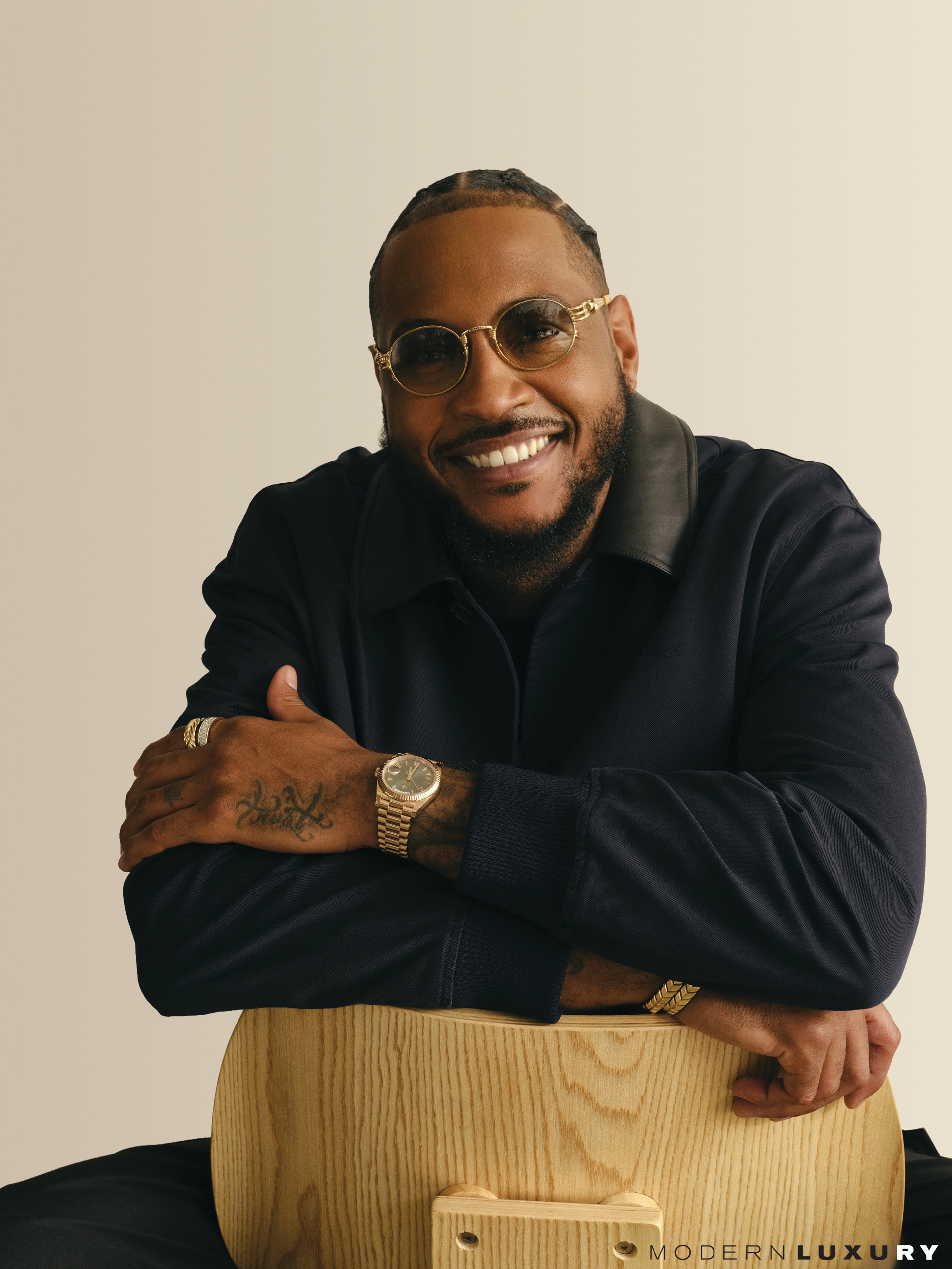 Dior jacket; Rolex Day-Date; David Yurman Chevron band ring in 18K yellow gold, Streamline band ring in 18K yellow gold with diamonds and Chevron woven bracelets in 18K yellow gold and black nylon; Anthony’s own glasses.